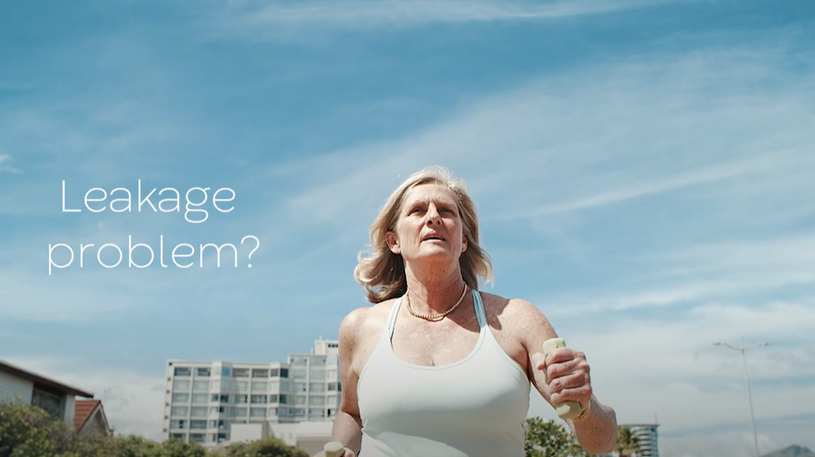 a woman with a white tank top and a white tank top with a building in the background
