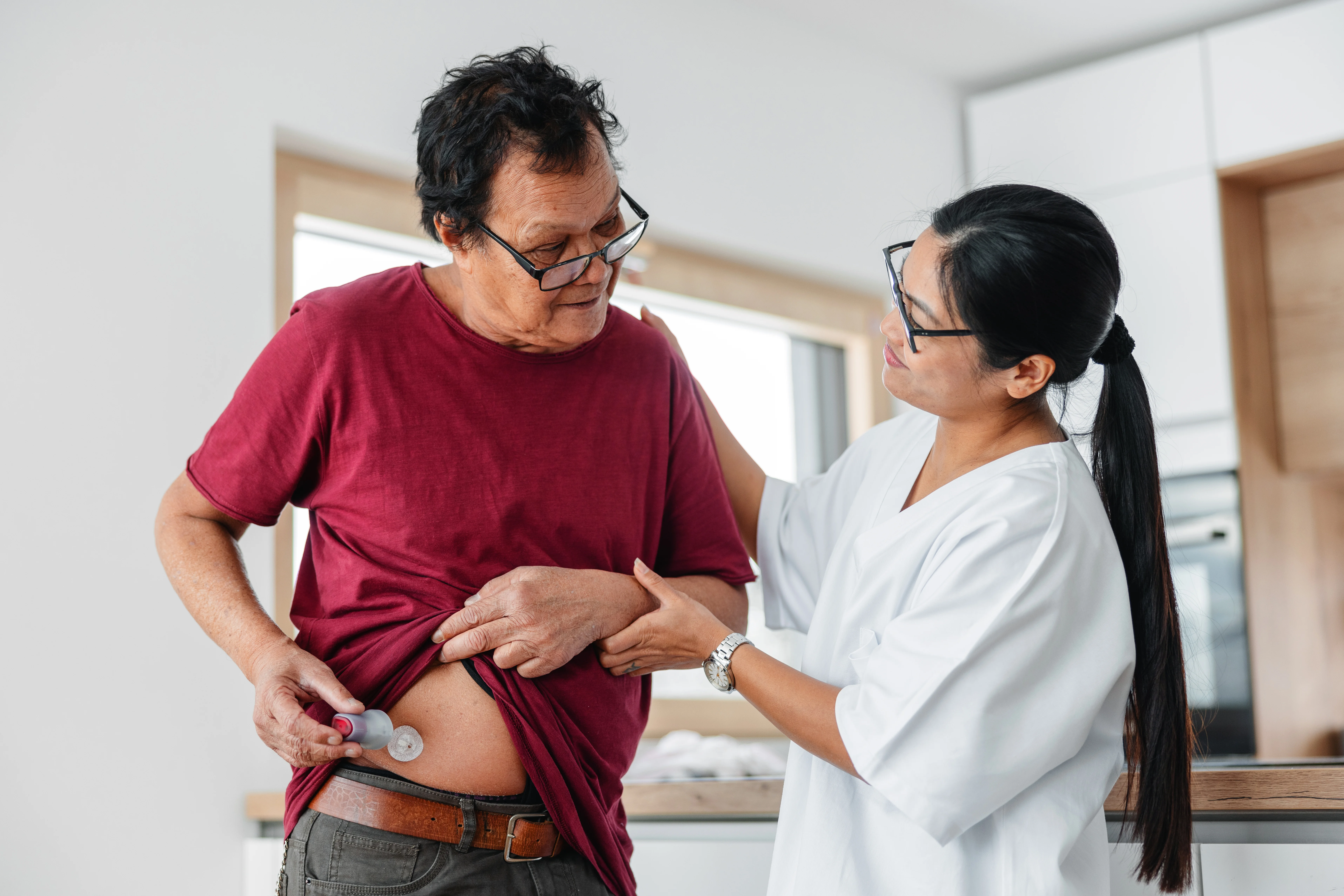 a man and a woman looking at a device