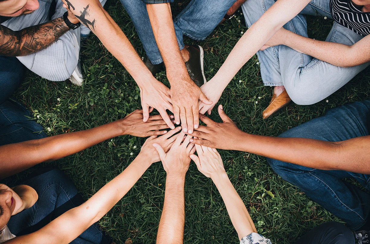 a group of people holding hands