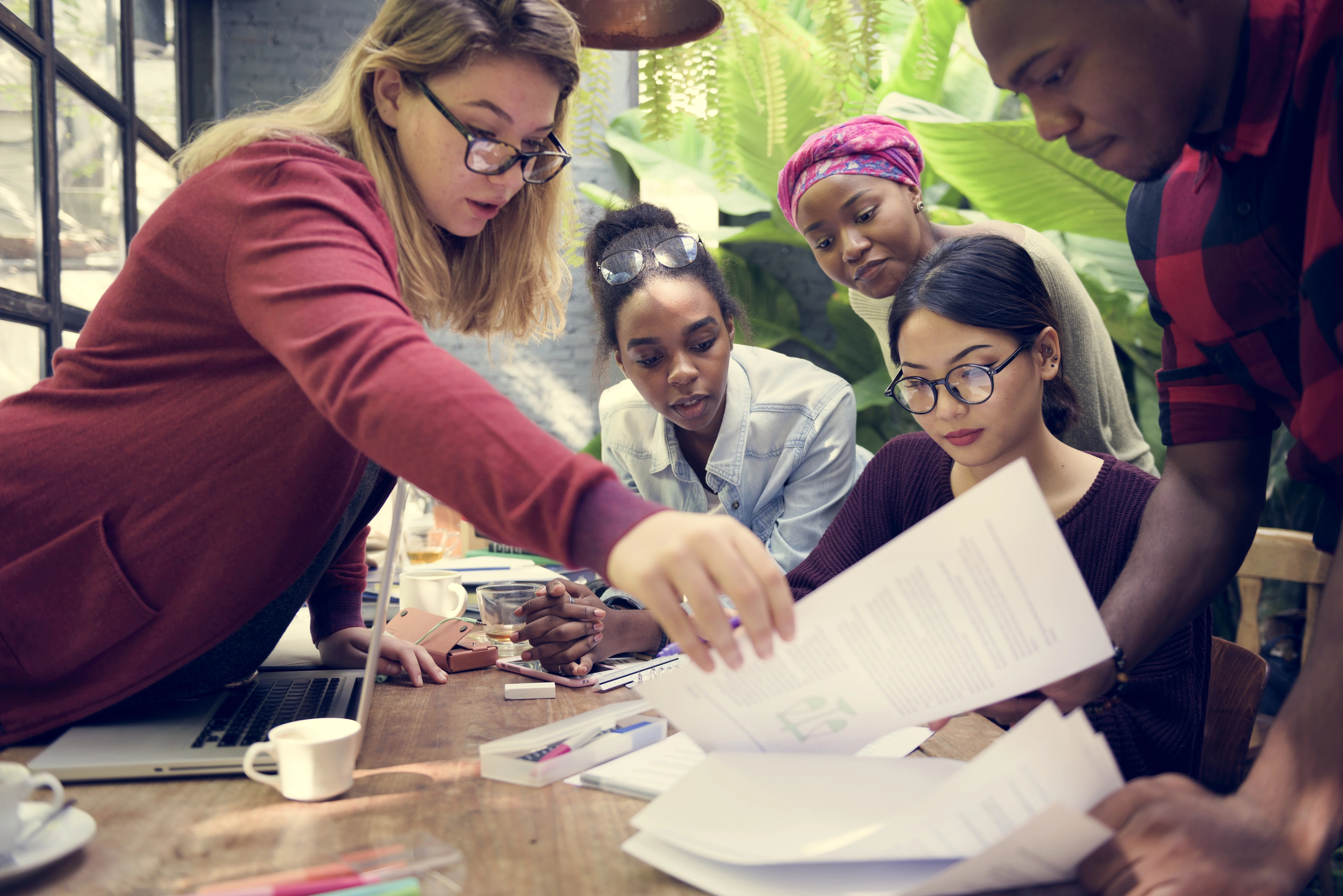a group of people looking at a paper