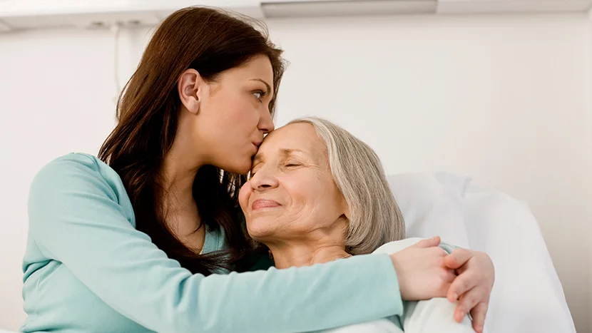 a woman kissing a woman on the cheek